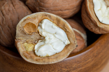 Open and broken walnut shells lying on the table