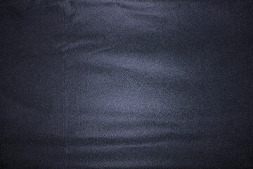 Black cloth background with a little lighting in the center