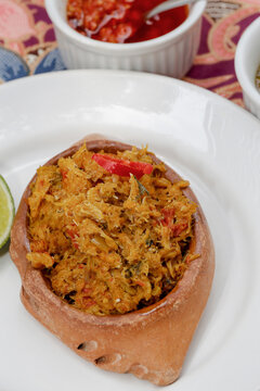 Brazilian food: crab cone or casquinha de siri in portuguese, on white dish with saucer and pepper