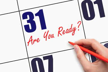 31st day of the month. Hand writing text ARE YOU READY on calendar date.