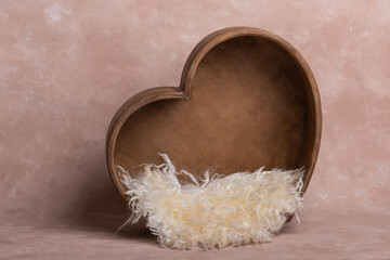 background texture empty space for baby with wooden heart and mattress. basket for a newborn photo shoot. heart made of wood, decorated with cute plush toys