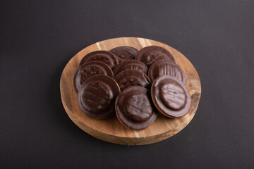 photo of cookies on a wooden board on a black background