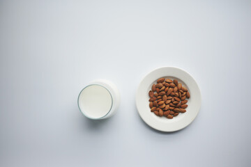  top view of almond nut and milk on white background 