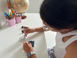 Girl messing with robotics