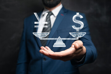 Dollar and yen on scales from the net. Man holding in his hand