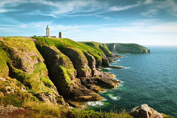 Panoramic view of scenic coastal landscape with traditional lighthouse at famous Cap Frehel peninsula on the Cote d'Emeraude, commune of Plevenon, Cotes-d'Armor, Bretagne, northern France - obrazy, fototapety, plakaty