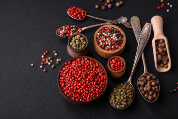 Composition, concept, consisting of several types of different colors of allspice in bowls and spoons