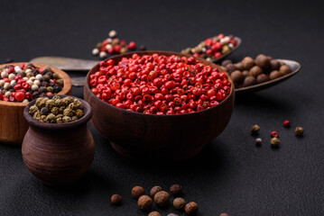 Composition, concept, consisting of several types of different colors of allspice in bowls and spoons