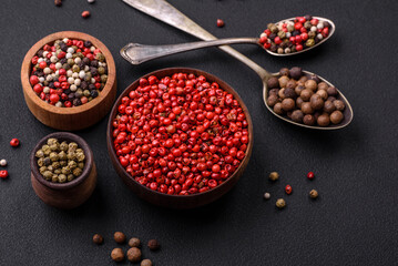 Composition, concept, consisting of several types of different colors of allspice in bowls and spoons