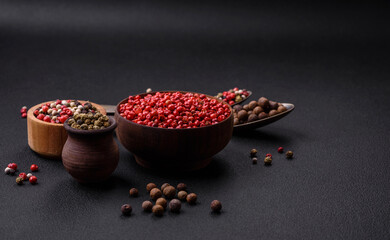 Composition, concept, consisting of several types of different colors of allspice in bowls and spoons