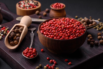 Composition, concept, consisting of several types of different colors of allspice in bowls and spoons