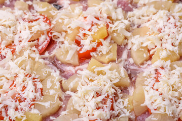 A dish consisting of meat, tomatoes, pineapple, cheese, spices and herbs