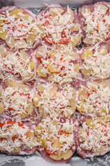 A dish consisting of meat, tomatoes, pineapple, cheese, spices and herbs