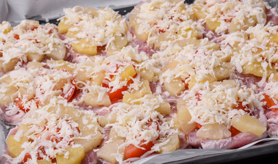A dish consisting of meat, tomatoes, pineapple, cheese, spices and herbs