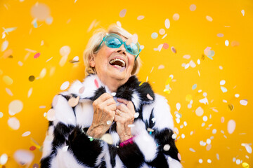 Happy grandmother posing on colored backgrounds