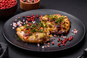 Meat baked in the oven with pineapple, tomatoes, cheese, spices and herbs