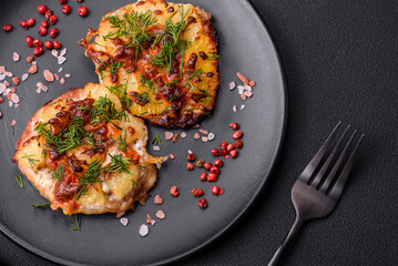 Meat baked in the oven with pineapple, tomatoes, cheese, spices and herbs