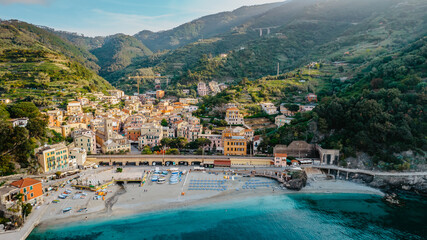 Fototapeta premium Aerial view of Monterosso and landscape of Cinque Terre,Italy.UNESCO Heritage Site.Picturesque colorful coastal village located on hills.Summer holiday,travel background.Italian Riviera with beaches