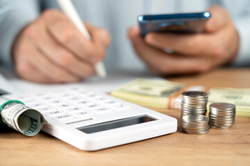 Business accounting concept, Business man using calculator with computer laptop, budget and loan paper in office..