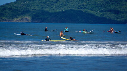 Surfers waiting to catch a wave in Tamarindo, Costa Rica
