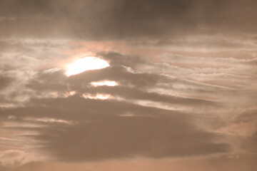 Close-up of the Sun between clouds