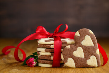 A stack of chocolate and vanilla heart cookies or biscuits  with heart patterns. Love dessert for Valentine's day. selective focus