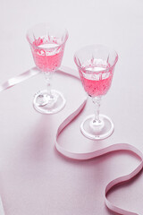 Two pink cocktails for Valentine's day celebration. Love and anniversary setting with hearts. Romantic concept