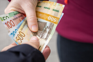 Norwegian money passing from hand to hand, Giving Norwegian kroner, Cash payment, Financial flow,...