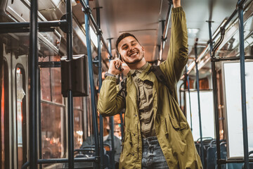 Obraz na płótnie Canvas Man with the Phone in Public Transport