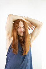 Funny young man with beard and red long hair 