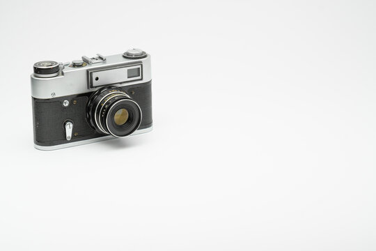Old vintage film camera isolated on white backgorund. Copy space 