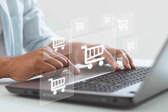 e-commerce, online shopping concept. Businessman using computer laptop to order in online store, shopping on internet, concept on virtual screen with hands typing and entering on keyboard.