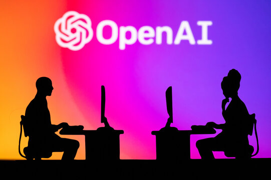 NEW YORK, USA, 25. JANUARY 2023: Open AI Web Developers at Work. Man and woman software engineers sitting in open office. Logo of Open AI in background. Brainstorm, Artificial Intelligence. Teamwork