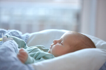 the newborn boy is sleeping. cute beautiful baby is sleeping closeup portrait of a beautiful...