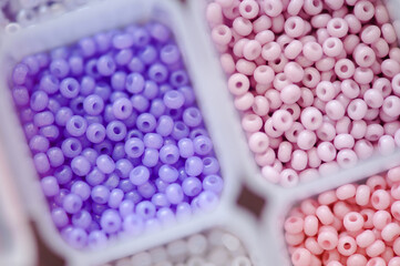 Colorful beads in plastic box organizer closeup. Handmade and hobby materials.