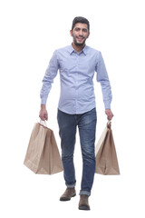 young man with shopping bags striding forward.