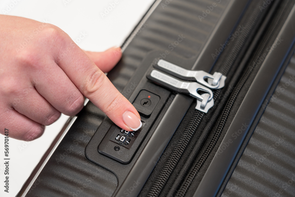Wall mural selecting the numbers on the combination lock of the suitcase with your finger to open it
