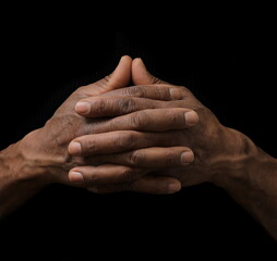 praying to God with hand together on grey black background with people stock photo