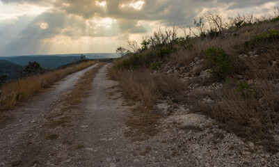 Storm brewing over a dirt road in Texas Hill Country