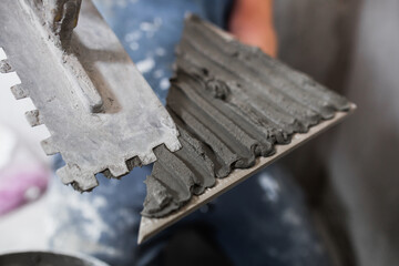 Laying porcelain tiles in the bathroom - durable reliable tiles on the floor in the bathroom - wear-resistant material in the finish