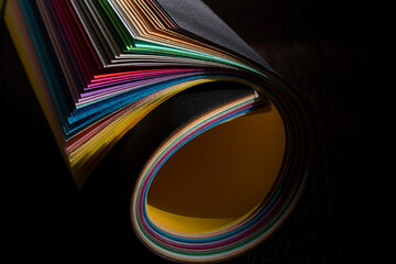 Abstract background with lines, colorful paper sheets on the black background