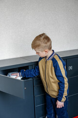 Boy client using automated self service post terminal machine or locker. Mail shipping concept