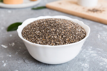 Chia seeds in bowl on colored background. Healthy Salvia hispanica in small bowl. Healthy superfood