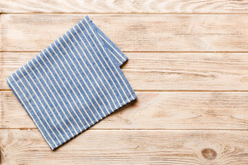 top view with blue kitchen napkin isolated on table background. Folded cloth for mockup with copy...