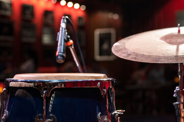 Percussion instruments with microphone for an intimate lighting concert indoors. Drum, Conga, musical environment. 