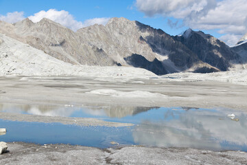 Obraz premium The desert lunar high mountain landscape next to the biggest Italian glacier and the lake in Adamello - Brenta Nature Park, Trentino, Italy.