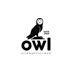 owl silhouette logo standing on rock
