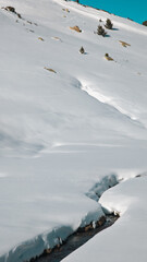 landscape with snow covered mountains and a river