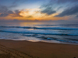 Summer sunrise at the seaside with clouds and haze