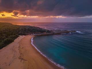 Rain clouds and dawn over the beach, sea and mountain